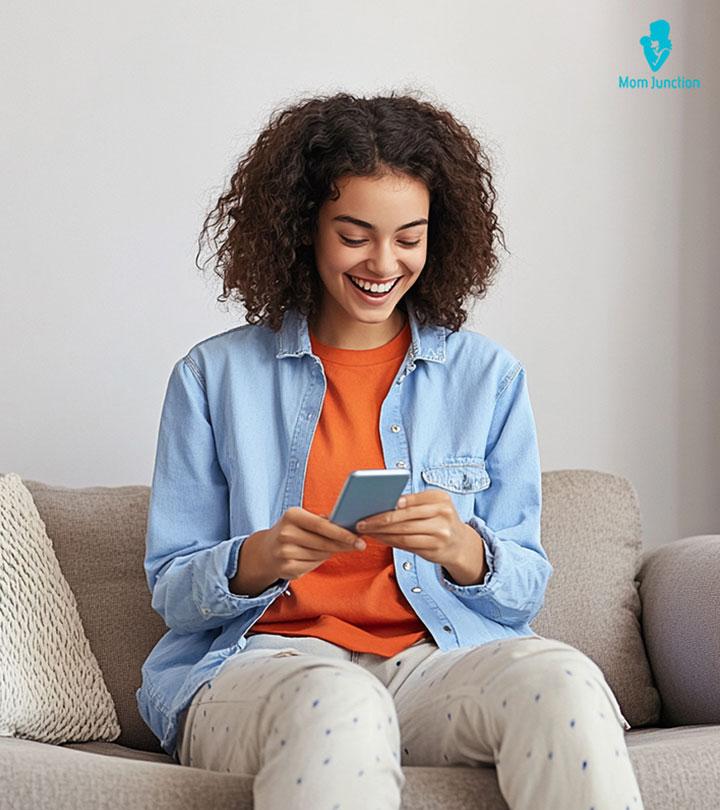 Girl-Smiling-While-Reading-Flirty-And-Funny-Questions-On-Her-Phone