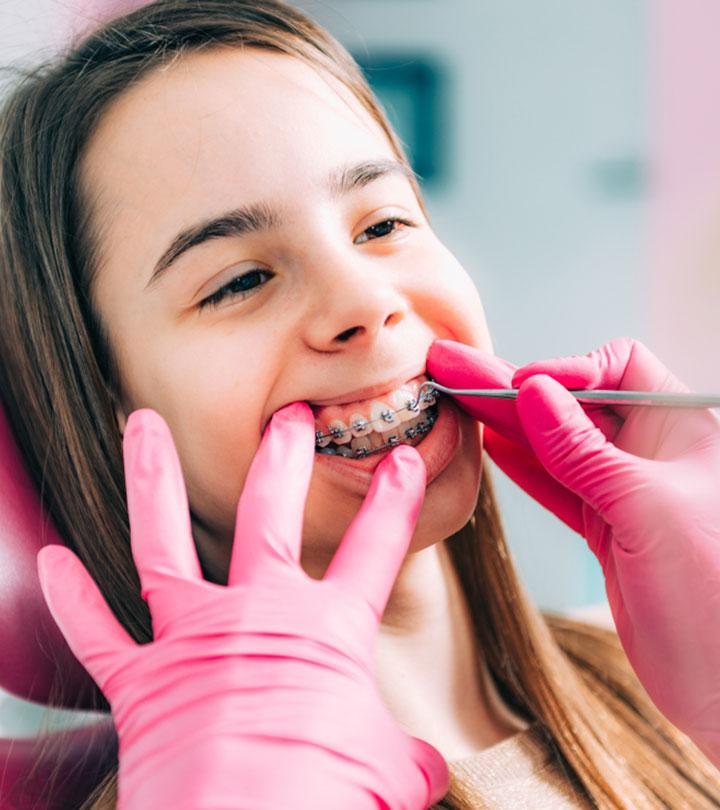 A Dentist Checking On A Girl With Braces