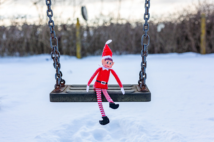 The Elf on the Shelf on a swing