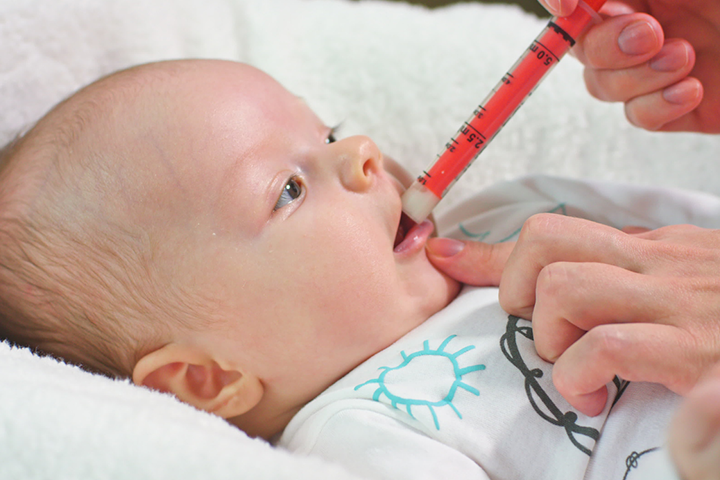 Insert the syringe’s tip into the baby’s mouth and release the medicine.