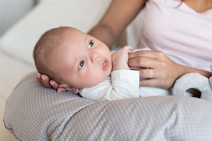 Use a pillow for support during baby syringe feeding